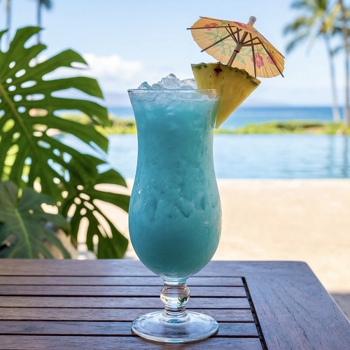 Blue Hawaii cocktail in a hurricane glass